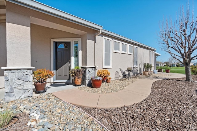 entrance to property with stucco siding