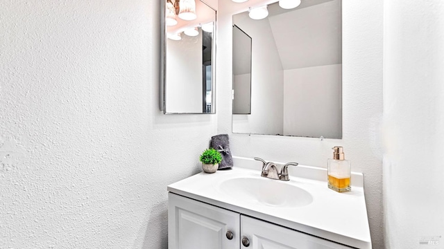 bathroom with vanity and a textured wall