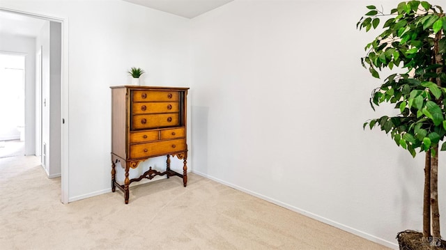 bedroom with baseboards and light carpet