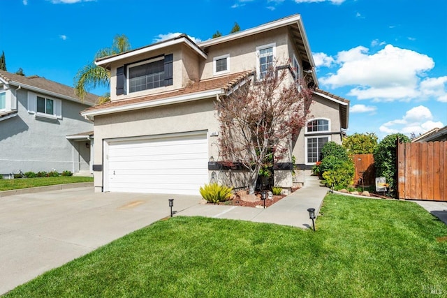 traditional-style home featuring stucco siding, concrete driveway, an attached garage, and fence