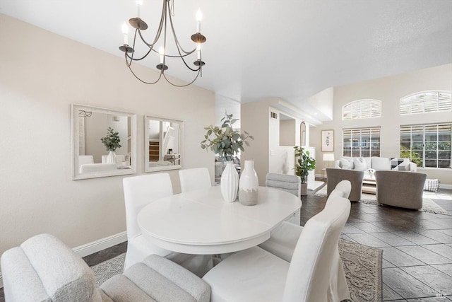 dining space with baseboards and a chandelier