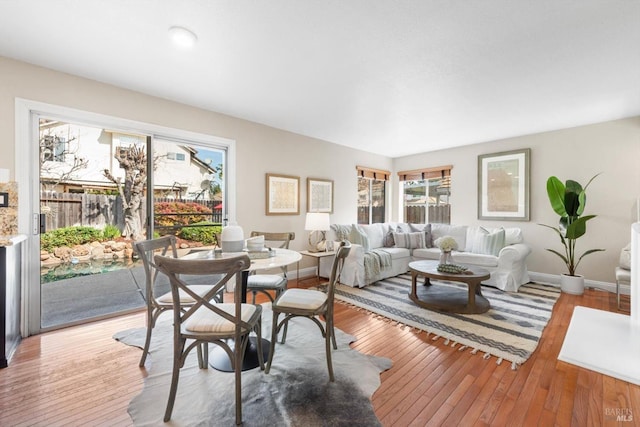 dining room featuring baseboards and wood-type flooring