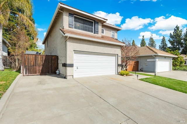 traditional-style home featuring stucco siding and fence