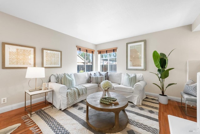 living area featuring baseboards and light wood-style floors