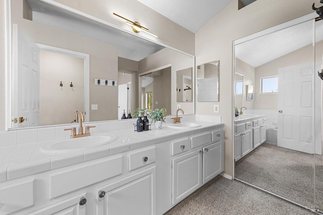 full bath with lofted ceiling, carpet flooring, double vanity, and a sink