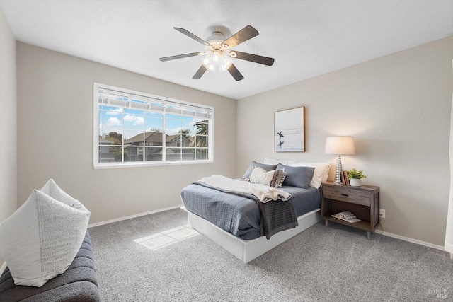 carpeted bedroom with a ceiling fan and baseboards