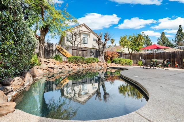 exterior space with a patio area and a fenced backyard