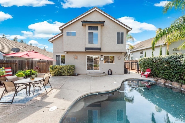 view of swimming pool with a patio area, a fenced in pool, and a fenced backyard