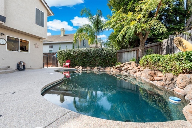 view of pool with a fenced in pool, a fenced backyard, and a patio area