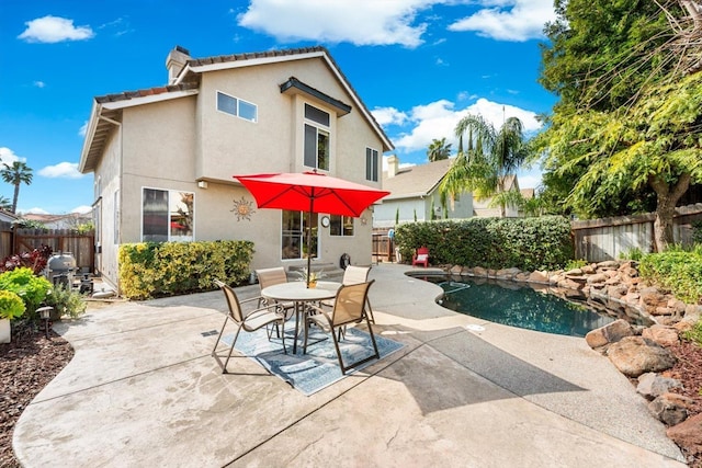 back of property featuring a patio area, stucco siding, and a fenced backyard