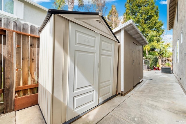 view of shed featuring fence