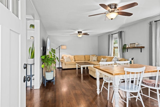 dining area with dark wood finished floors and a ceiling fan