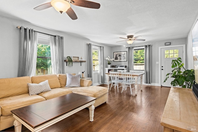 living room featuring a textured ceiling, a healthy amount of sunlight, wood finished floors, and ceiling fan