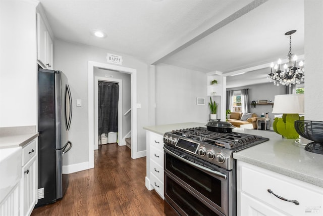 kitchen with baseboards, dark wood-style flooring, appliances with stainless steel finishes, white cabinetry, and a chandelier