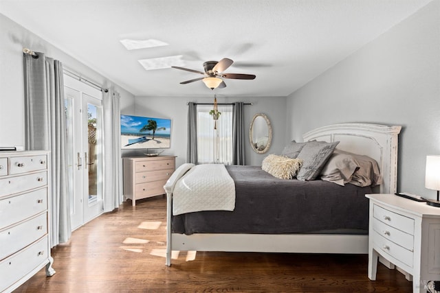 bedroom with wood finished floors, multiple windows, access to exterior, and ceiling fan