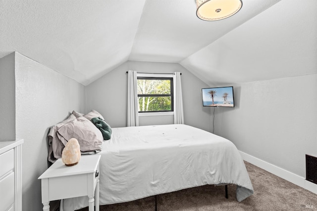 bedroom featuring baseboards, carpet floors, and vaulted ceiling