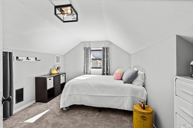 carpeted bedroom featuring lofted ceiling, baseboards, and visible vents