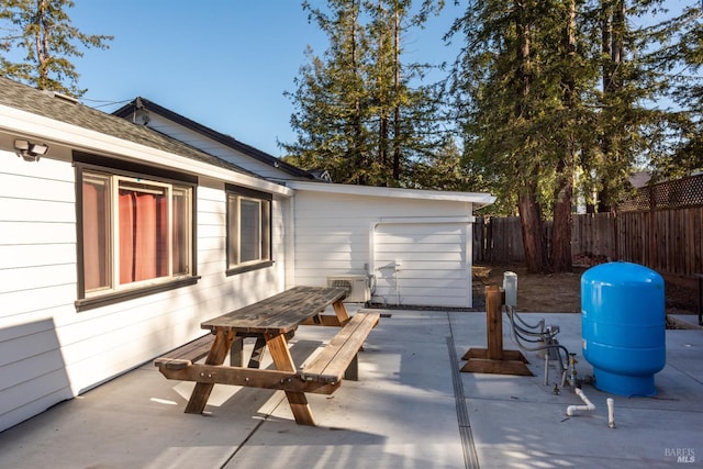 view of patio with outdoor dining area and fence