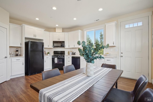 dining area featuring recessed lighting, visible vents, and wood finished floors