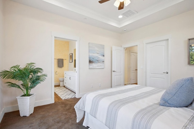 carpeted bedroom with baseboards, visible vents, a tray ceiling, recessed lighting, and crown molding