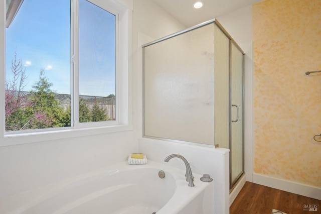 full bathroom with baseboards, recessed lighting, a stall shower, wood finished floors, and a bath