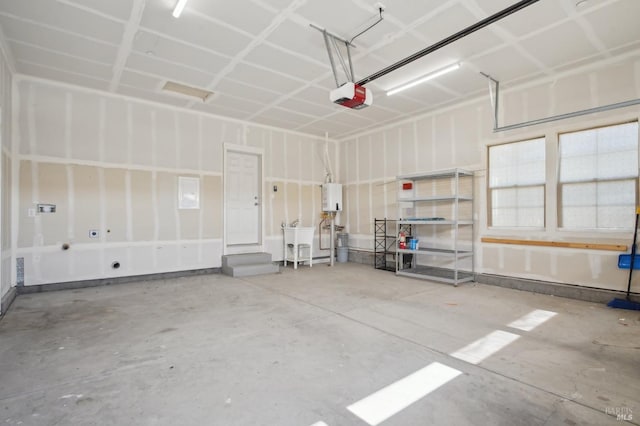 garage featuring water heater and a garage door opener