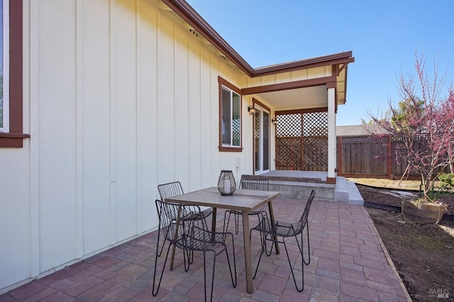 view of patio / terrace featuring outdoor dining area and fence