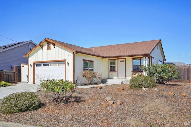 ranch-style home with a garage, covered porch, driveway, and fence