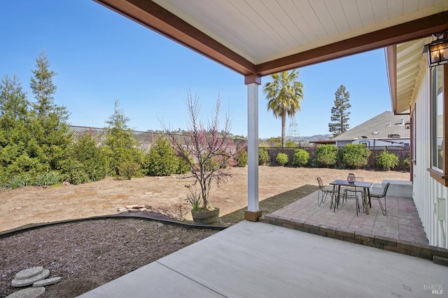 view of patio featuring a fenced backyard and outdoor dining space