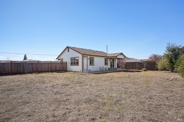 rear view of house featuring a patio and a fenced backyard