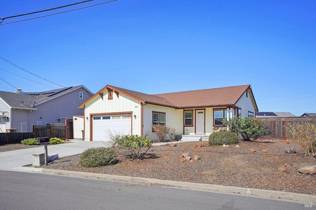 single story home featuring concrete driveway, an attached garage, and fence