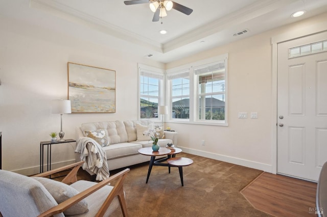 carpeted living room featuring visible vents, baseboards, ceiling fan, a tray ceiling, and recessed lighting