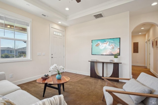 living room featuring arched walkways, visible vents, and recessed lighting