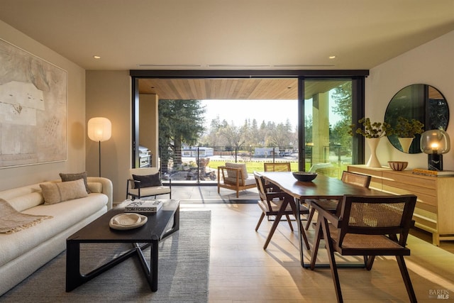 living area featuring recessed lighting, expansive windows, and wood finished floors