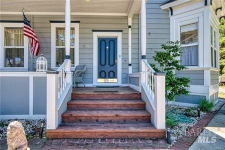 view of exterior entry with covered porch