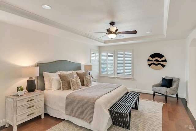 bedroom with recessed lighting, a raised ceiling, baseboards, and dark wood-style flooring