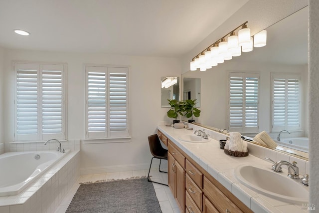 bathroom featuring a sink, a garden tub, double vanity, and tile patterned flooring