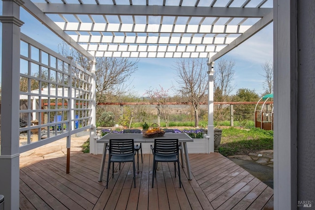 wooden terrace with outdoor dining space and a pergola