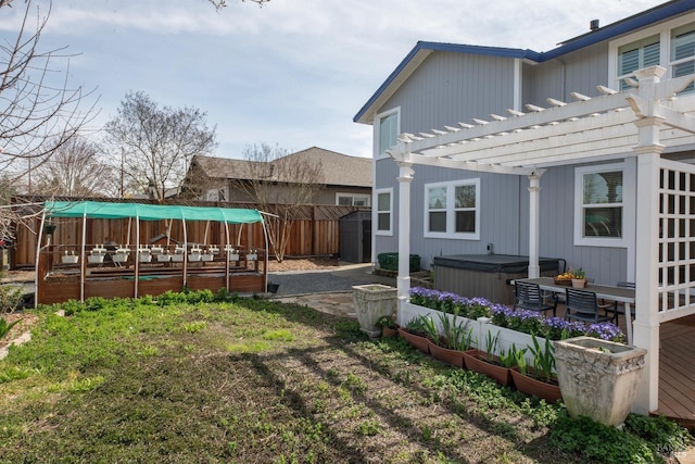 view of yard featuring a fenced backyard, a pergola, and a hot tub