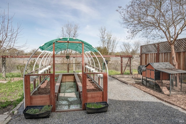 exterior space featuring an outbuilding, fence, and exterior structure