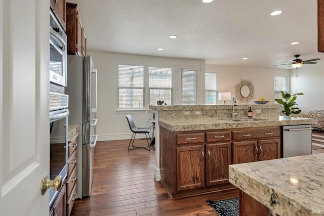 kitchen with a wealth of natural light, light countertops, and a sink