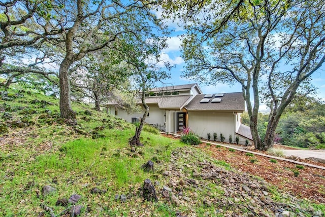 view of front of property featuring solar panels