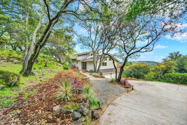 view of front of house featuring concrete driveway, an attached garage, and stucco siding