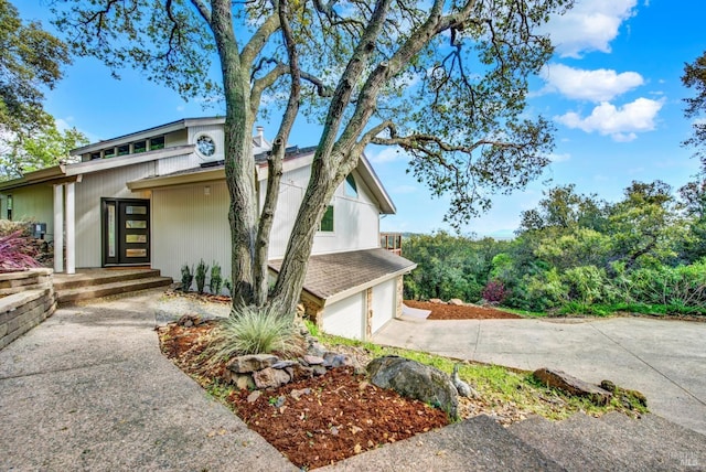 view of front of house with concrete driveway and an attached garage