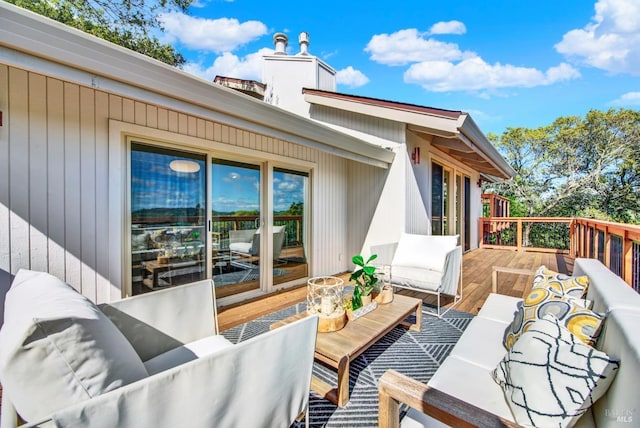 wooden terrace with an outdoor hangout area