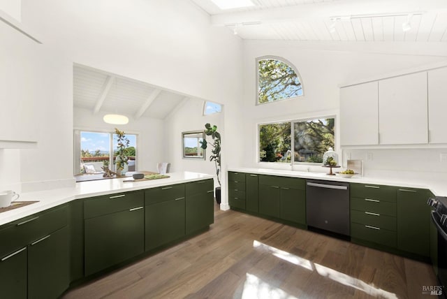 kitchen featuring green cabinetry, dishwasher, a sink, light countertops, and wood finished floors