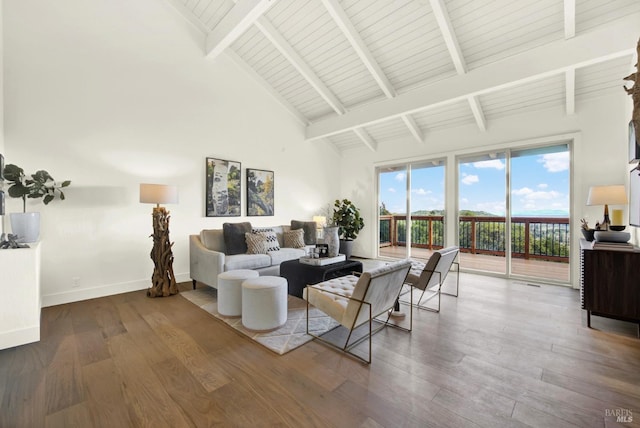 living area featuring beam ceiling, high vaulted ceiling, baseboards, and wood finished floors