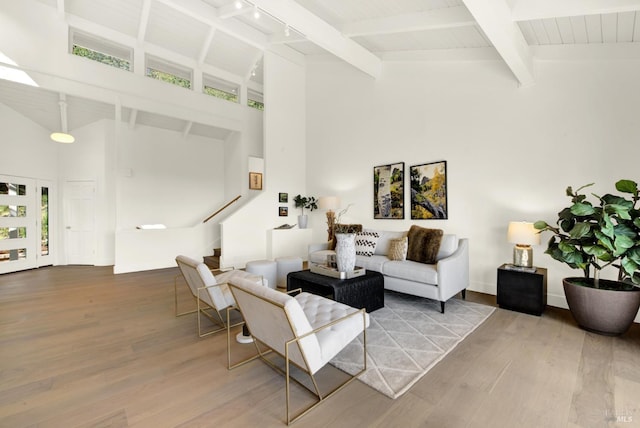 living room featuring stairs, wood finished floors, and high vaulted ceiling