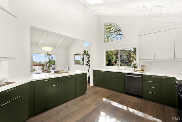 kitchen featuring green cabinetry, dishwasher, light countertops, wood finished floors, and a sink