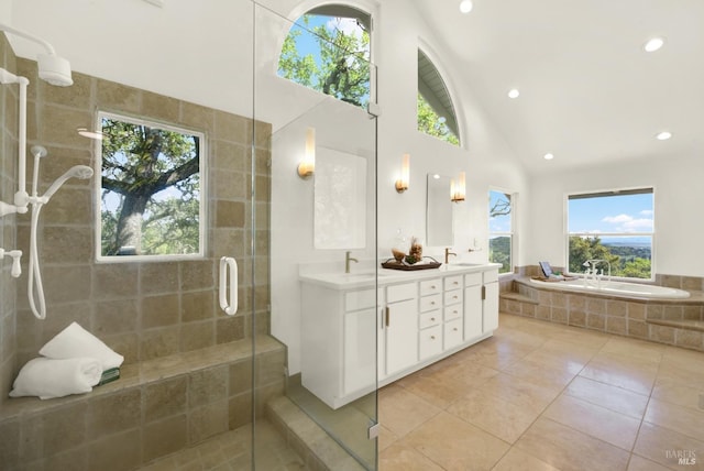 full bathroom with a garden tub, a sink, a stall shower, double vanity, and tile patterned floors